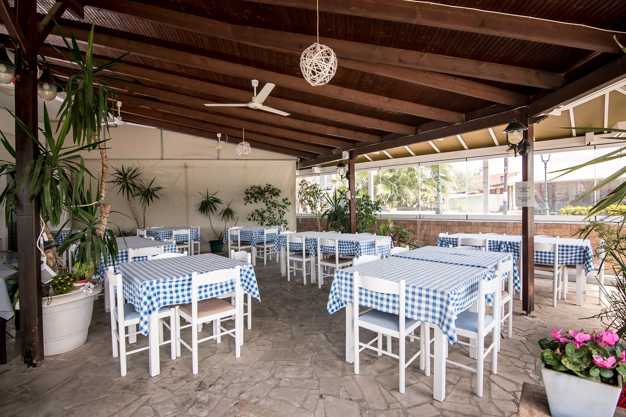 The covered dining area and its checked tablecloths