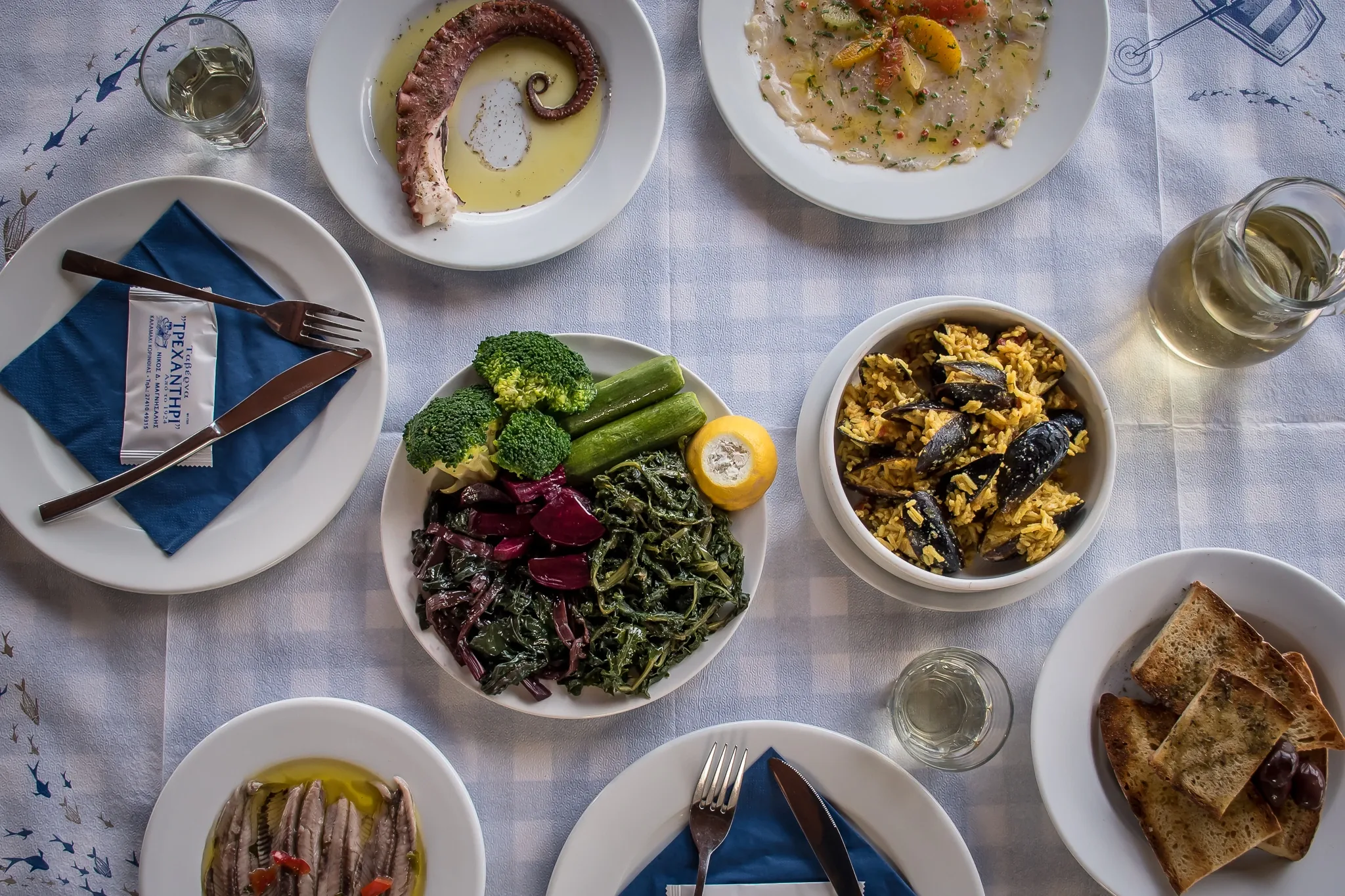 A table of octopus, wild greens and mussel pilaf